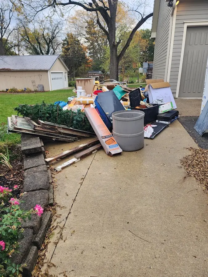 Dumpster being loaded with debris for Roofing Dumpster Rental in Summit Park